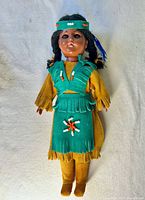 Front view of Carlson doll showing beadwork, leather clothing, headband and overall condition
