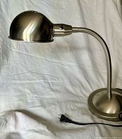 Full left-side view of brushed nickel desk lamp showing shade, gooseneck and base