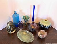 Group view of all nine glass and pottery items