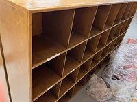 Front angled view showing cubby compartments and gold finish