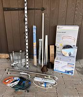 Overall lot showing ventilation fan box, ceiling light boxes, power strip, cords, grab bars, showerhead, utensil set and other hardware