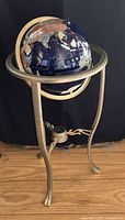 Full view of gemstone globe on stand