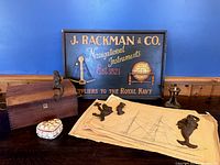 group shot of sign, boxes, mermaids, plans, lamp