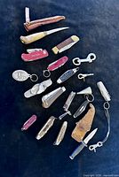 Full lot overview showing all knives, tools and accessories on black background