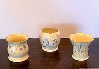 Front view of the three Lenox porcelain votive holders