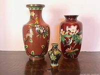 Front view of all three vases showing designs and relative sizes