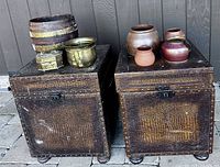 Two faux crocodile trunks with seven vessels on tops