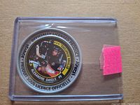 Front view of Alexandre Daigle Katch Coin in plastic holder