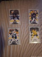 Front view of four O-Pee-Chee 4 Nations hockey cards in sleeves