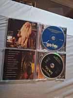 Open jewel cases showing both soundtrack CDs and inserts