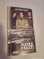 Front covers of both Icon CDs: Hoobastank and Puddle of Mudd