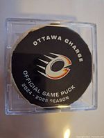 Front view of puck showing Ottawa Charge logo and season text