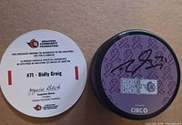 Autographed puck beside certificate of authenticity