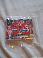 Front of stack showing Sam Montembeault MM-1 card in plastic sleeve