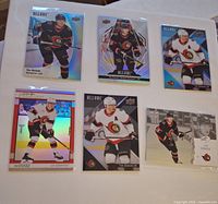 Front view of six Tim Stutzle hockey trading cards laid out in two rows