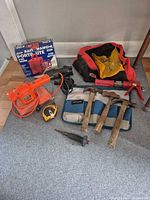 Group shot showing power tools, hammers, tape measure, tool bag, Porta-Lite box
