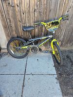 Right side view of complete bike leaning against fence