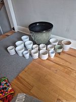 Group shot showing all ceramic planters and saucers on floor