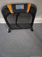 Front view of Chariot backrest seat panel showing mesh fabric, orange accent, and mounting brackets