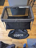 Playard fully assembled with carry bag in front