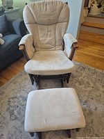 Front view of glider rocker chair and ottoman showing upholstery and overall style