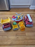 Group shot of all five plastic vehicles on floor