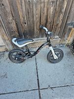 Left side view of Haro balance bike showing frame, wheels, and wear