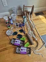 Full view of lot showing macrame hangers, seed trays, watering bulbs, mister, pots, wood tote