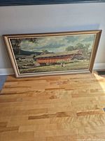 Full view of framed landscape print on floor