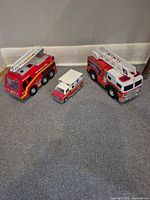 All three toy vehicles grouped on floor