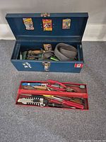 Closed toolbox open showing contents and tray