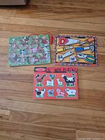 All three Melissa & Doug puzzle boards laid out on wood floor