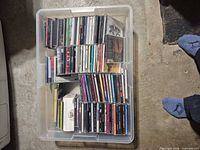 Plastic tote containing rows of audio CDs