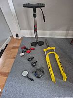 All items laid out: pump, fork, lights, pedals, lock, mirror