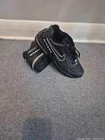 Side view of both Nike Air Max sneakers showing AIRMAX branding and swoosh