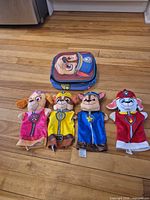 Group view of four puppets and lunchbox
