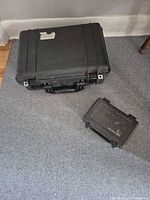 Large and small Pelican cases closed, top view showing exterior wear
