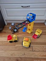 Full playset layout showing crane tower, rock chute, three vehicles, rocks and figures