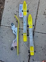 Complete stroller ski kit laid out: two long skis, one short assembly, instructions