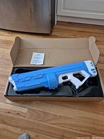 Water gun in open box with manual visible
