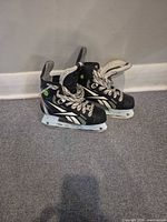 Full view of both Reebok skates standing side by side
