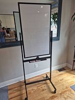 Full view of rolling whiteboard showing frame, board surface and wheels