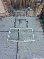 white basket and gray golf wall rack on patio surface
