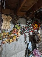 All four wreaths hanging on wall showing variety of decorations and sizes