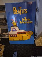 Full front view of the Beatles Yellow Submarine poster leaning against wall