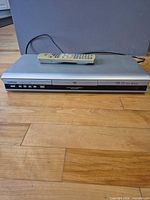 Front view of Toshiba SD-3860 DVD player with remote resting on top