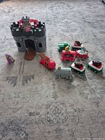 Overall view showing castle, catapult, ball, dragon figure and grouped train pieces