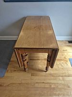 Table folded with both leaves down, narrow console configuration