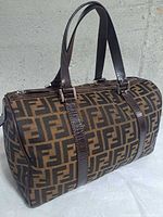 Front angled view of the Fendi Zucca Boston bag showing monogram canvas and leather handles