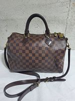 Front and side view of handbag with strap attached